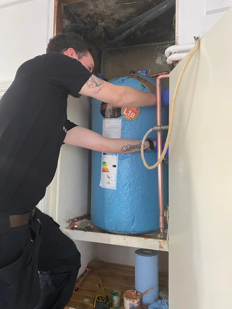 RAA engineer repairing a hot water cylinder